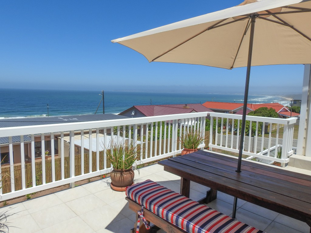 Sea-view deck with umbrella overlooking the bay from Julsie's Home