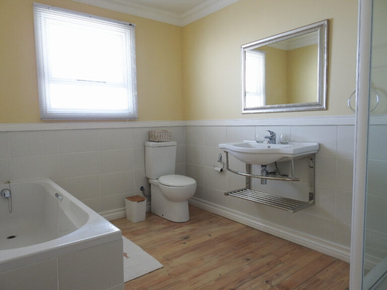 Room 2 en-suite bathroom with bath, basin and toilet