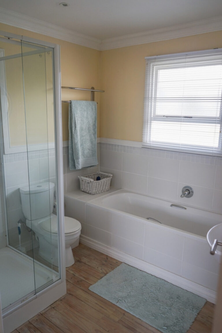 Shared full bathroom with bath, shower and window