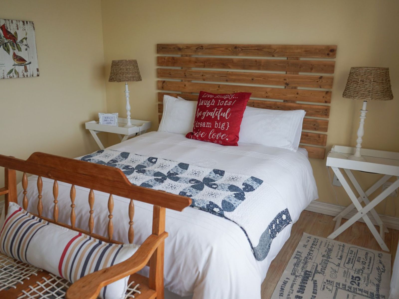 Room 2 at Julsie's Home: queen bed with a wooden headboard and day bench